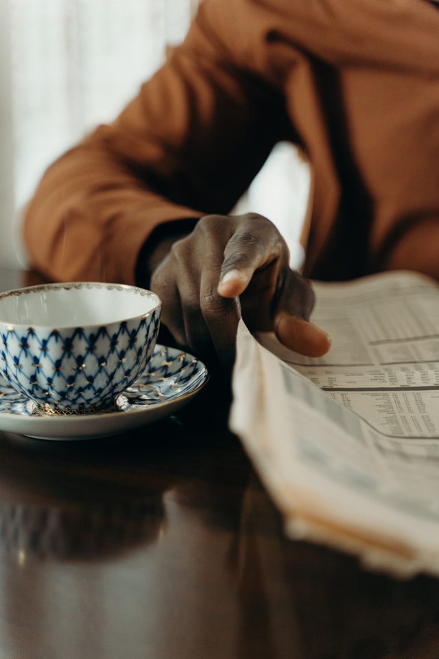 A close up of the hands of a man reading a newspaper. Perhaps reading about Sex Abuse in the News. Photo by cottonbro from Pexels