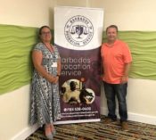 Dr. Jennifer Weeks on the left of a banner announcing the International Summit to Improve Outcomes for people who commit sexual Crimes, Justin Moyer, an educator on the ICAC on the right of the banner.