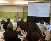 Dr. Jennifer Weeks presenting in front of a projector in Barbados to a diverse group of individuals on using psychology to improve outcomes for people who commit sexual crimes.