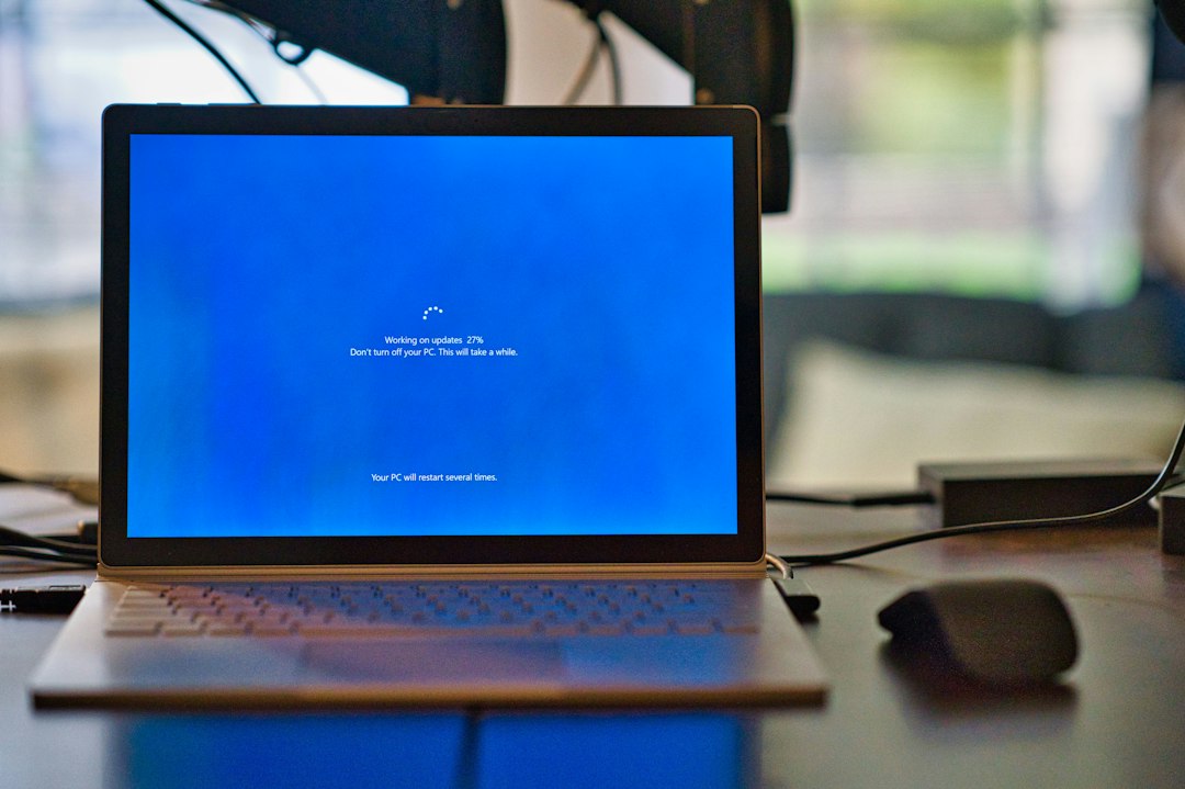Microsoft Surface laptop installing an operating-system update, illustrating patched Windows zero-days.
