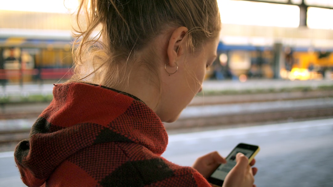 Person checking a smartphone, illustrating questions raised in the Meta child safety trial.