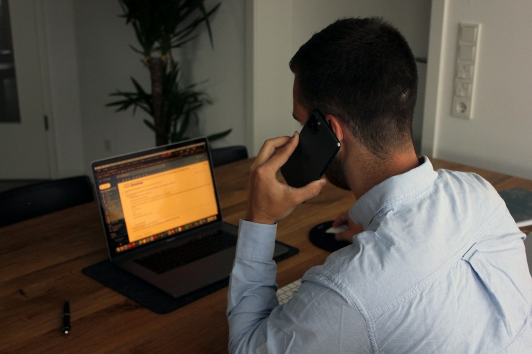 Businessperson on a smartphone call, illustrating an AI voice scam.