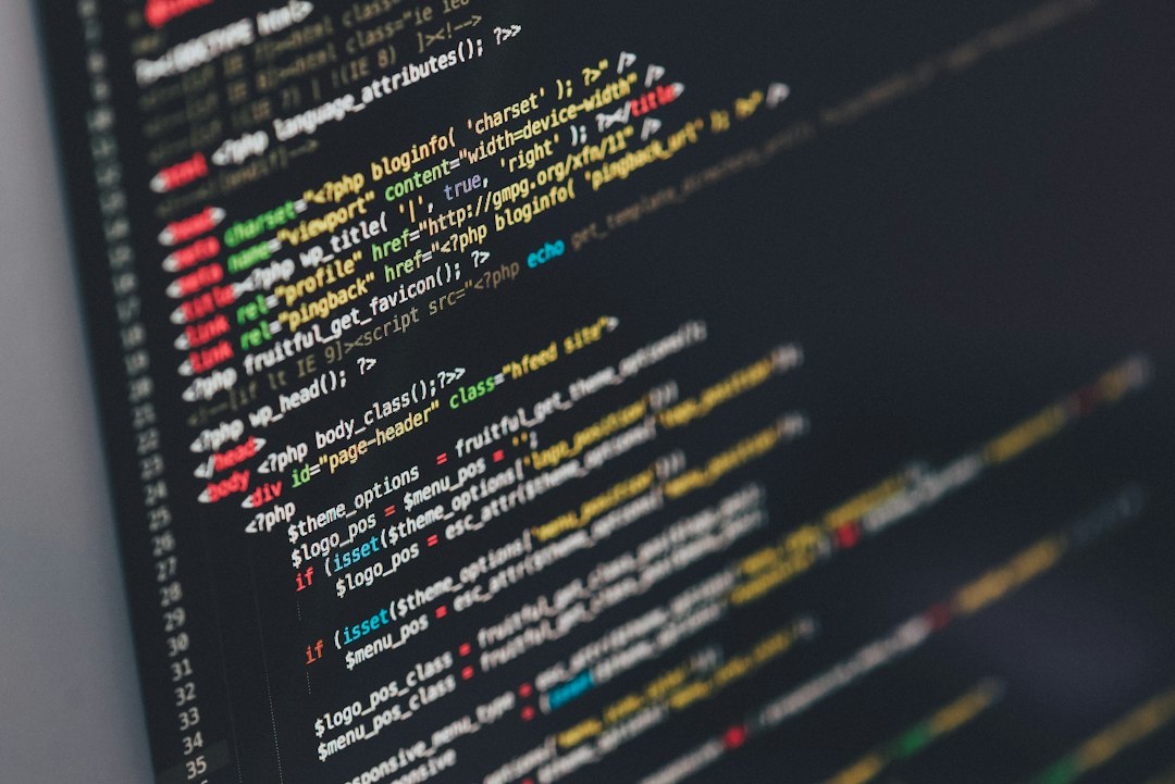 WordPress theme source code on a monitor, illustrating the Elementor Pro vulnerability.