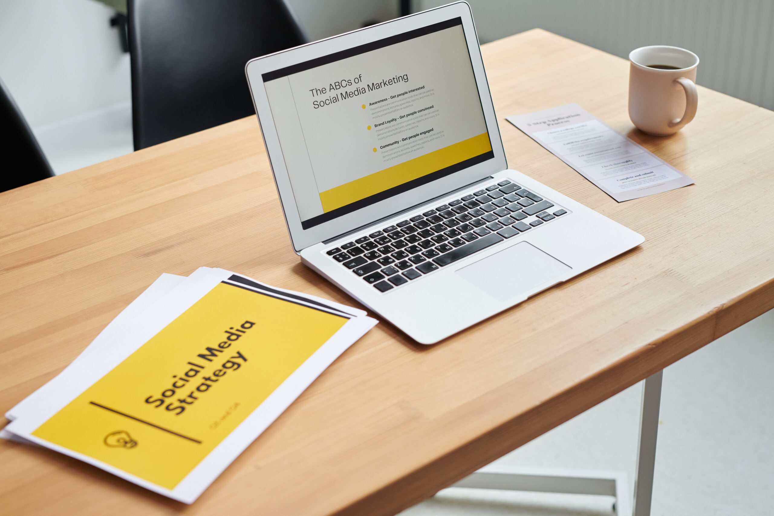 Laptop and social media strategy documents illustrating open source SEO and social media tools.