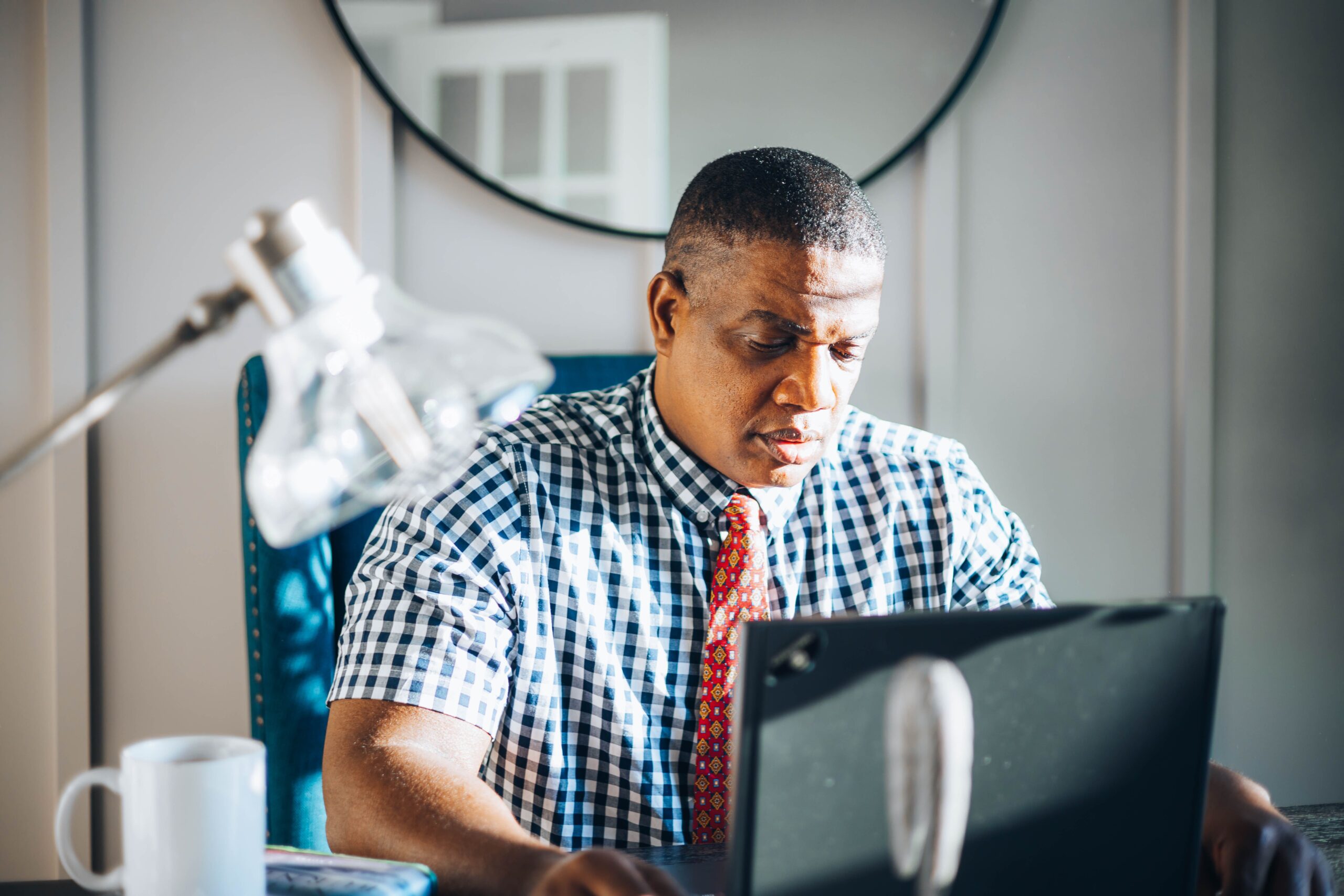 Office worker using a laptop, illustrating the Windows Server Exchange issue.