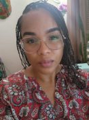 Image of Stephanie Figueroa, MA Counselor wearing glasses in a therapeutic office setting